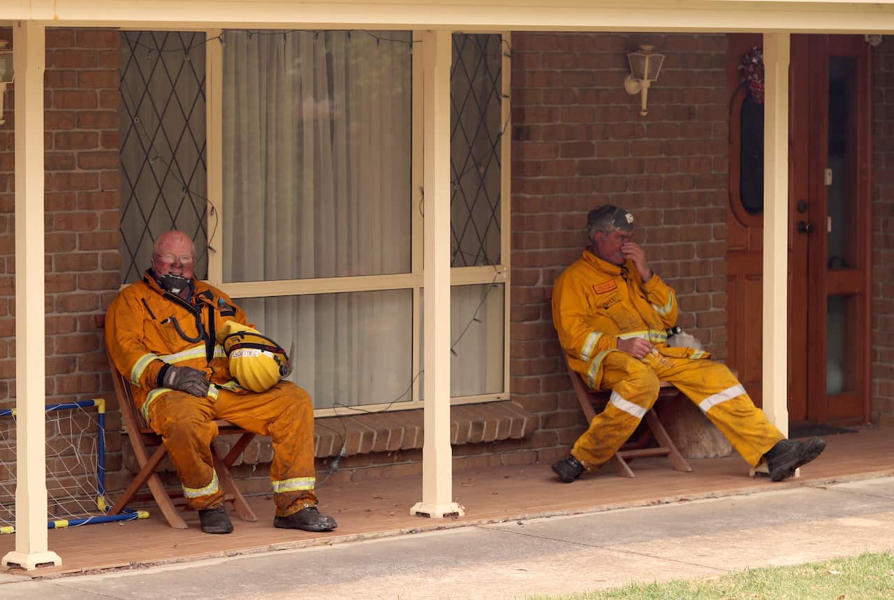 CFS firefighters are seen on Jacaranda Drive at Woodside in the Adelaide Hills.