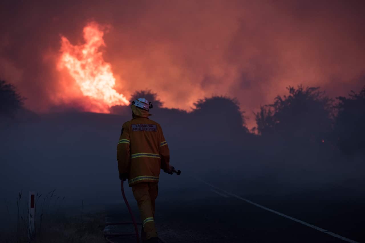 Firefighters work to contain the Pelham Road Fire in southern Tasmania.