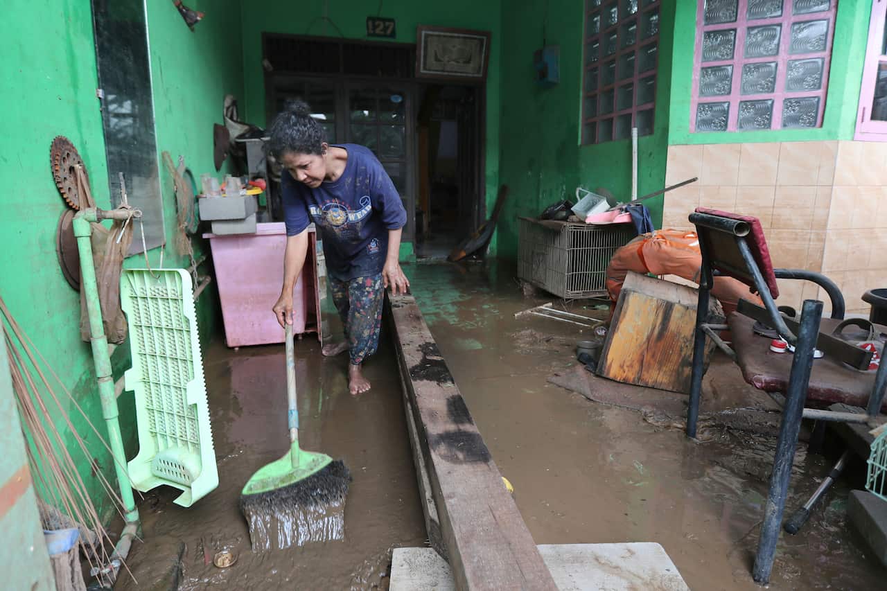 A woman cleans her flooded house in Tanggerang on the outskirts of Jakarta, Indonesia.