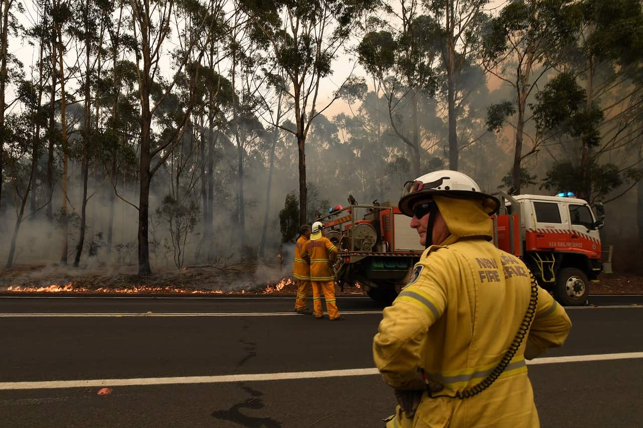 Firefighters contain a small bushfire which closed the Princes Highway south of Ulladulla on Sunday.