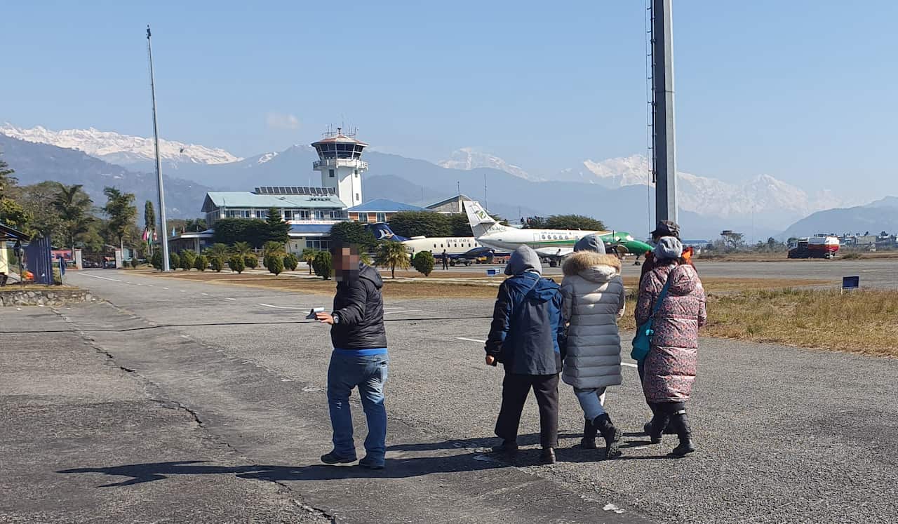 Family members of South Korean nationals who went missing in an avalanche, walk at Pokhara Airport in Nepal