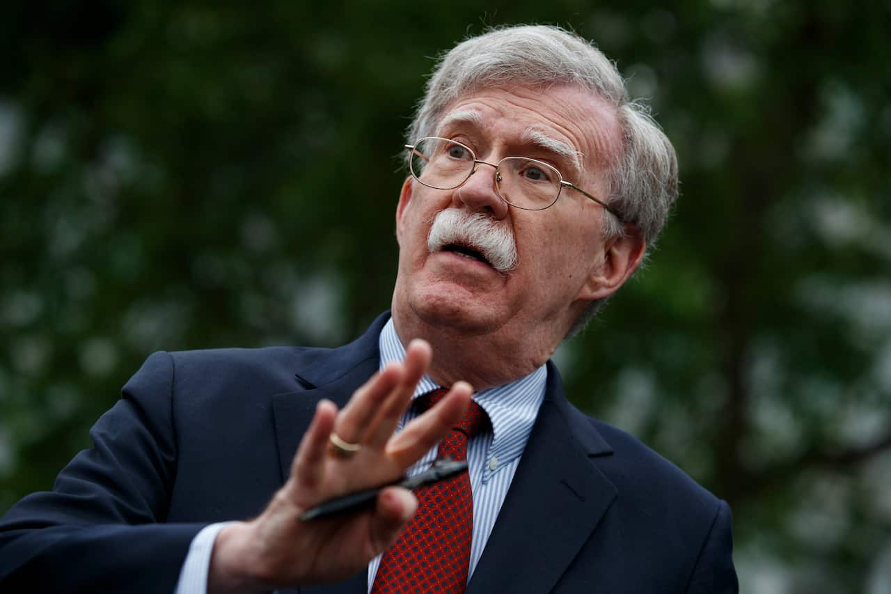FILE - In this May 1, 2019 file photo, National security adviser John Bolton talks to reporters outside the White House in Washington. (AP Photo/Evan Vucci)
