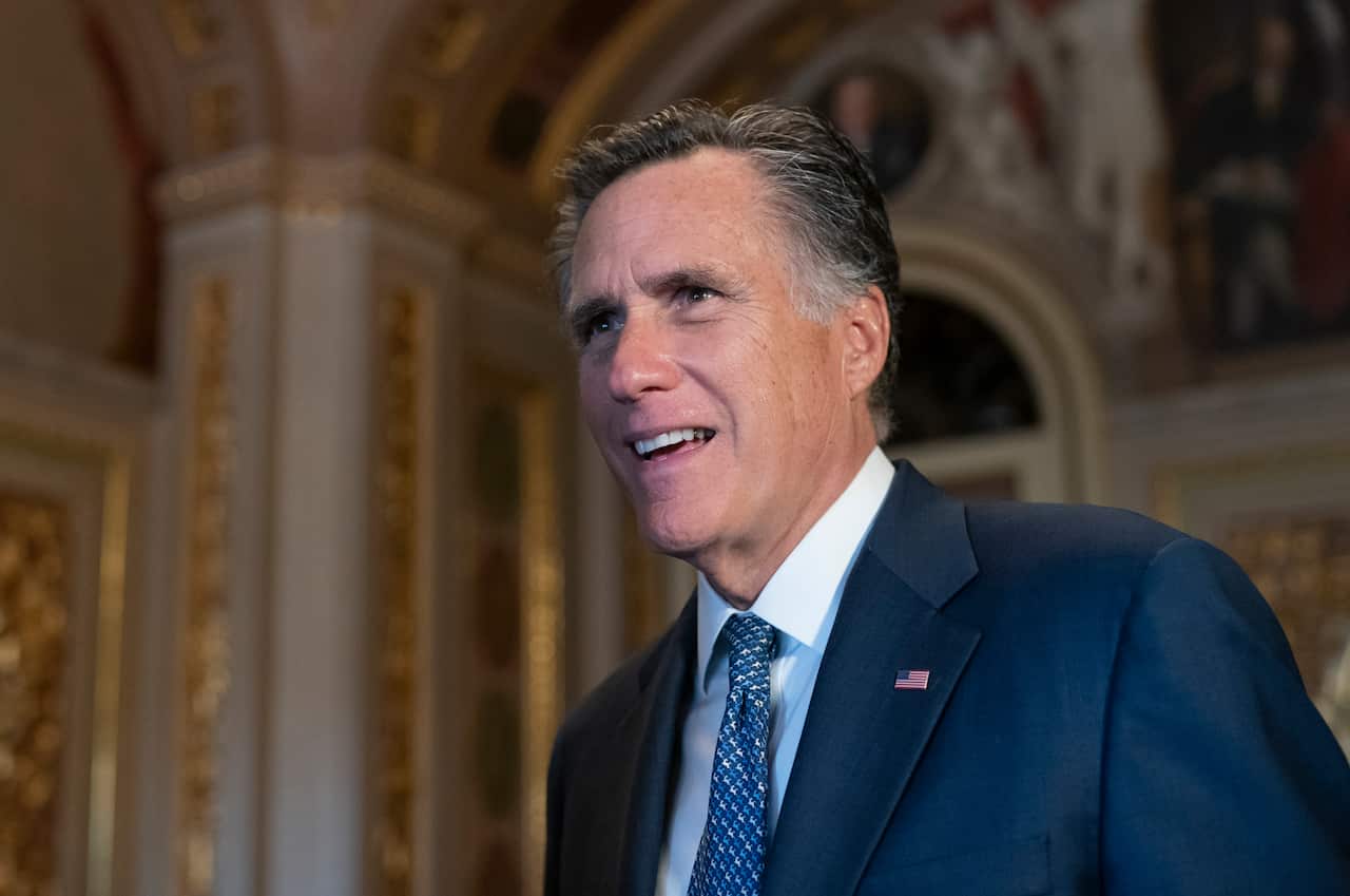 Sen. Mitt Romney, R-Utah, talks to a reporter outside the Senate chamber during a break in President Donald Trump's impeachment trial, at the Capitol in Washington, Wednesday, Jan. 29, 2020. (AP Photo/J. Scott Applewhite)