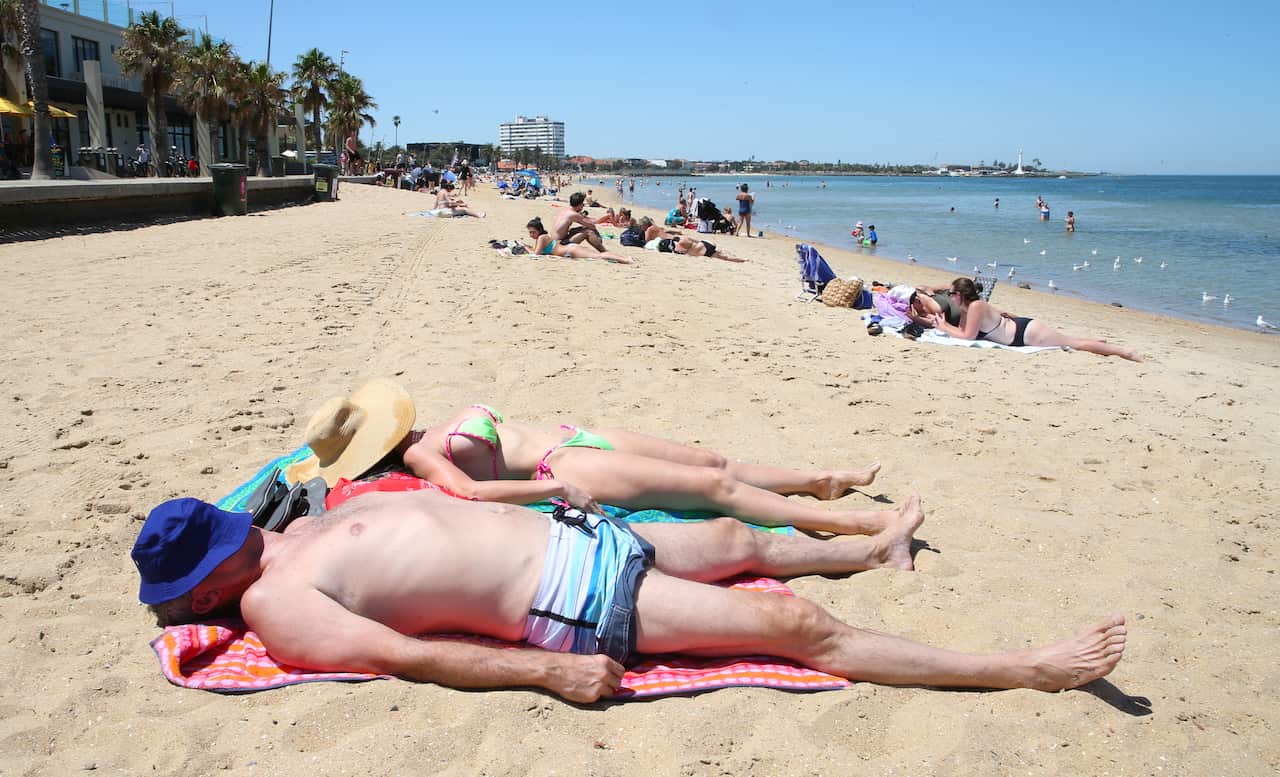 Beachgoers escape Melbourne's heat at St Kilda beach.