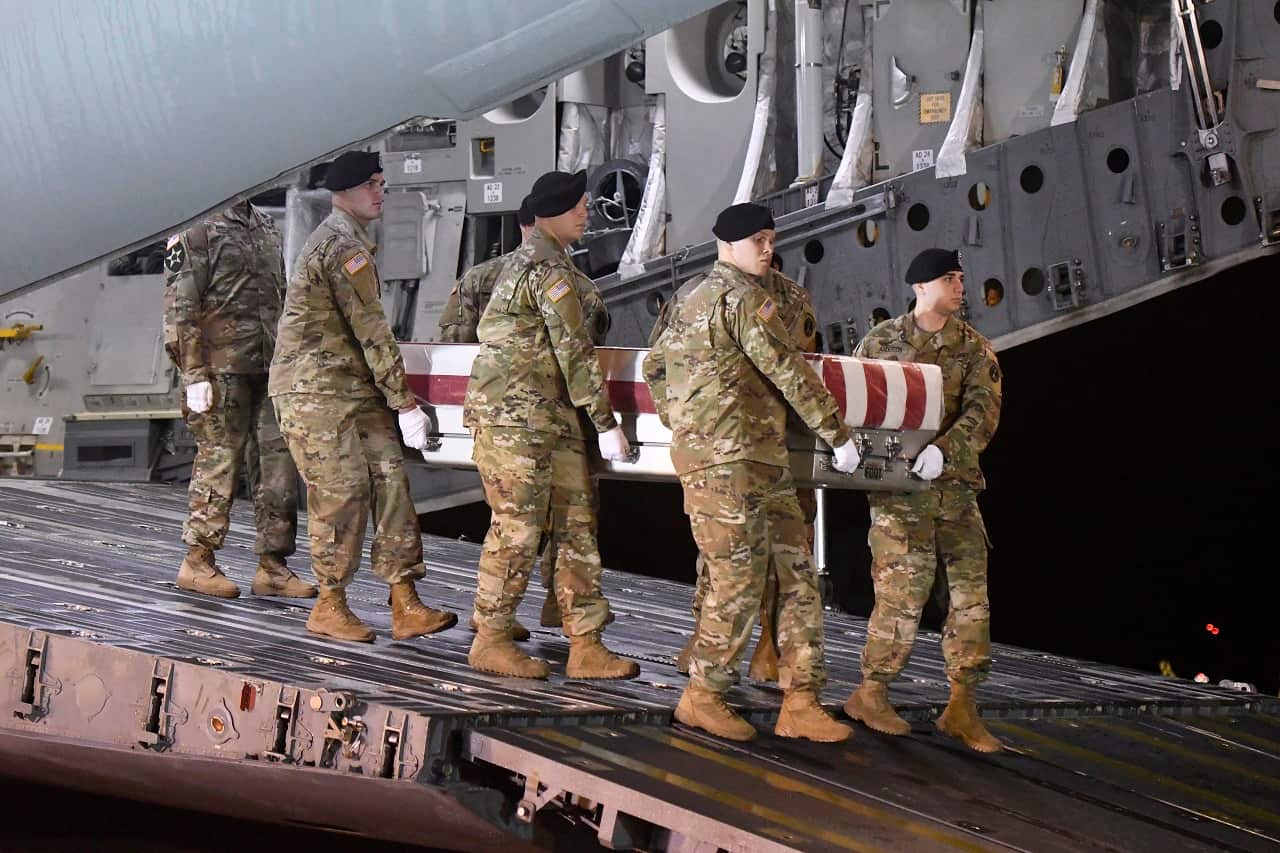 A team moves a case containing the remains of a US soldier who died in Afghanistan.