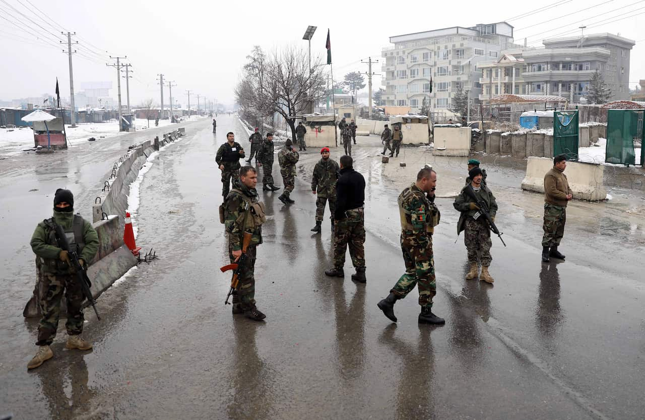 Afghan security officer stands guard.