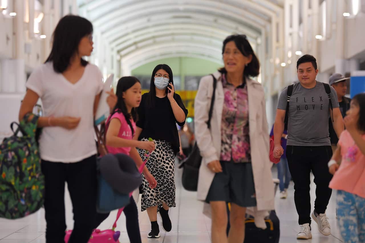 Australian evacuees who were quarantined on Christmas Island over concerns about the COVID-19 coronavirus arrive at Sydney Airport in Sydney.