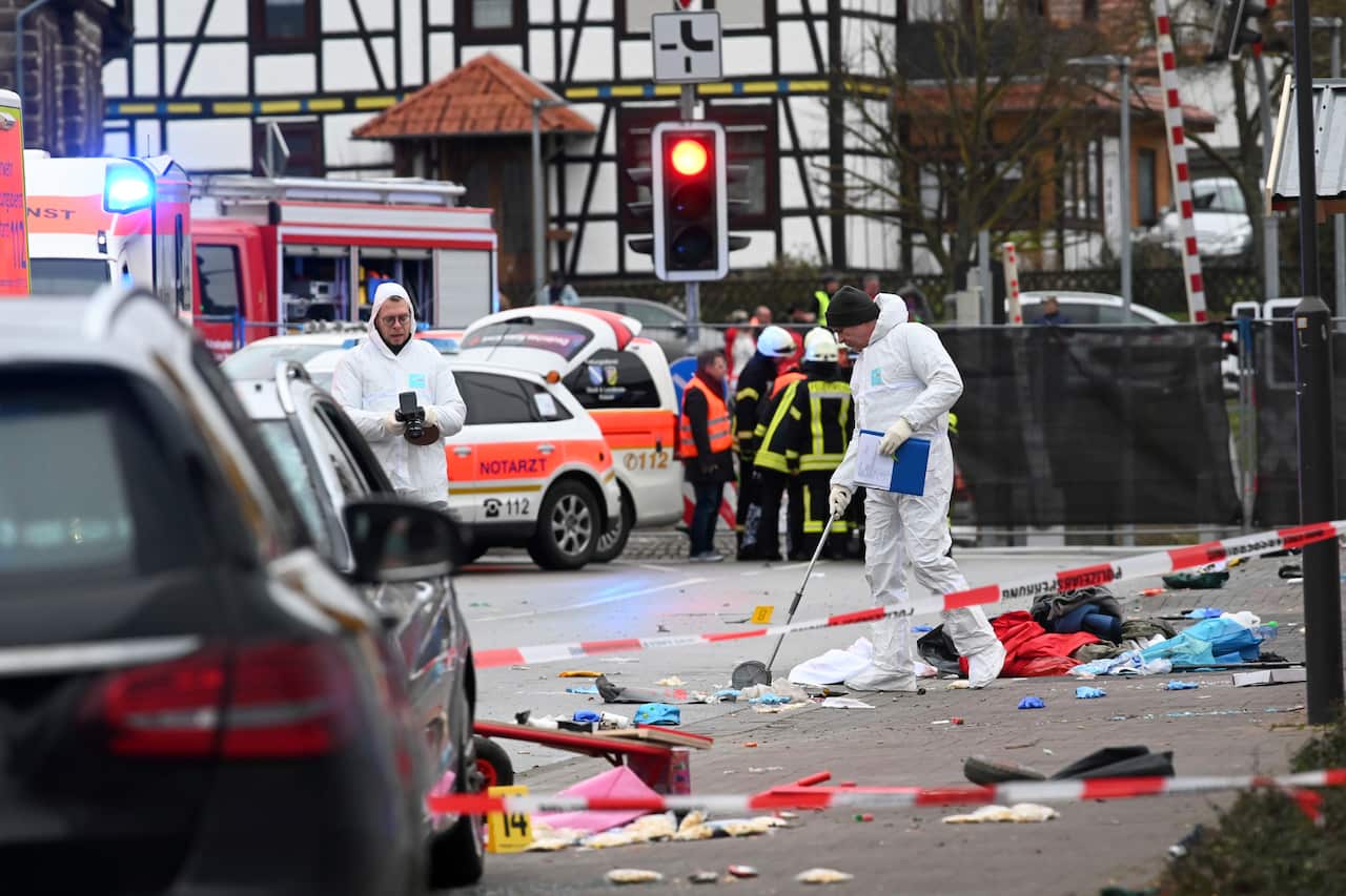 Police and rescue workers respond after a car crashed into a carnival parade in Volkmarsen, central Germany.