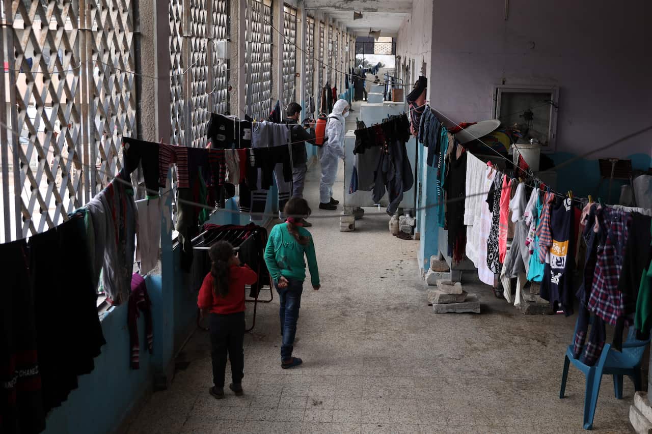 Volunteers from Violet Organization spray disinfectants as precautionary against coronavirus at shelters in Idlib, Syria, 20 March 2020 (issued 22 March 2020).  EPA/YAHYA NEMAH