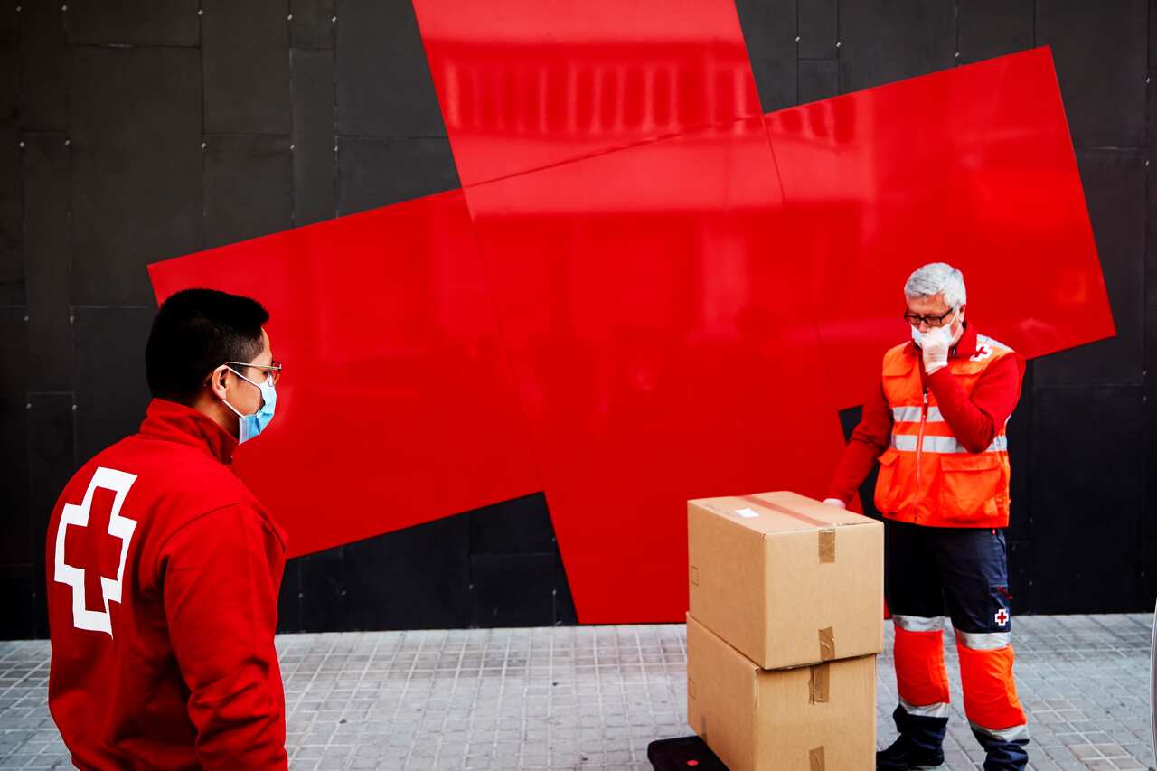 Spanish Red Cross volunteers deliver urgent aid and food for people in need in Barcelona, Catalonia.