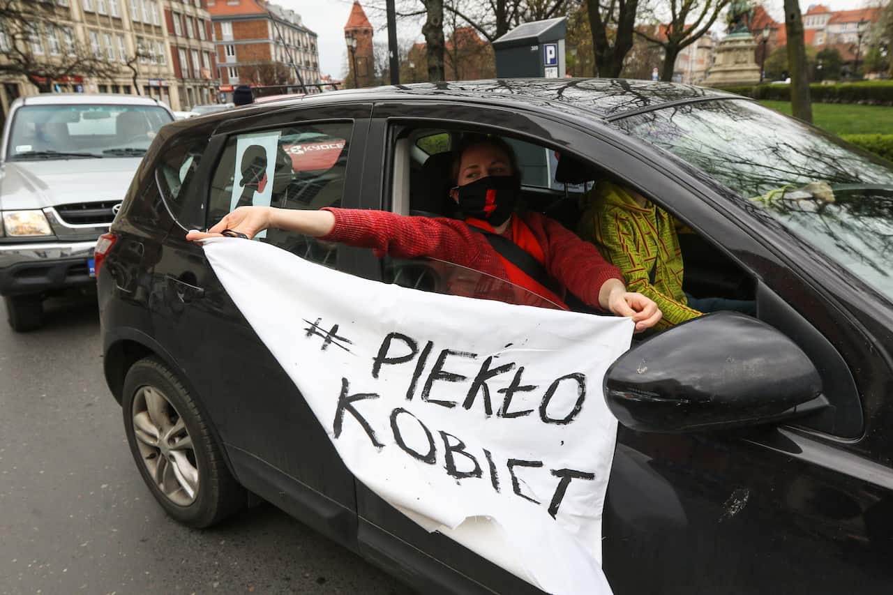 Protest participant inside the car with 'Women's hell' banner is seen in Gdansk, Poland.