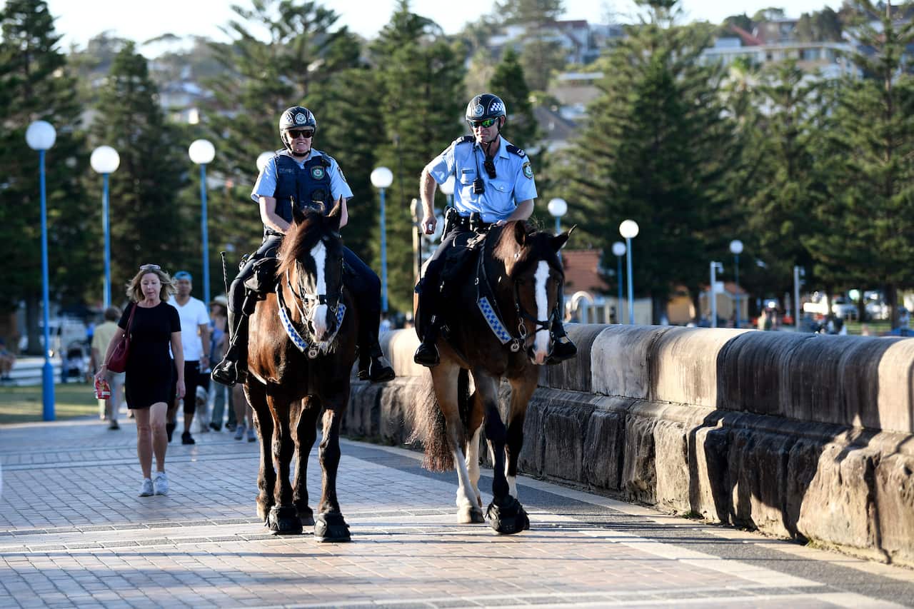 Mounted police are seen patrolling a closed Coogee Beach in Sydney on Friday. 