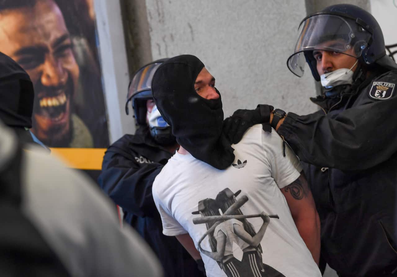 Authorities are combatting new outbreaks in Germany as thousands protest against restrictions.