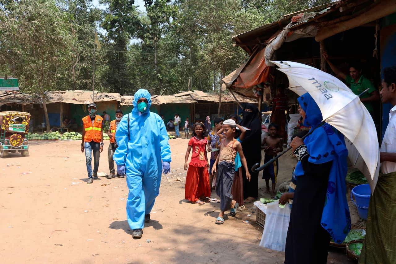 A health worker from an aid organisation walks wearing a hazmat suit at the Kutupalong Rohingya refugee camp in Cox's Bazar, Bangladesh.