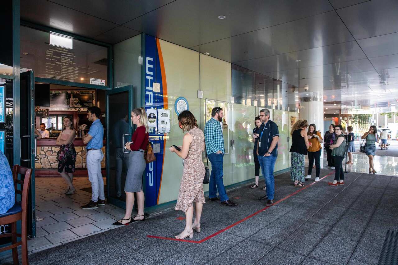 People wait in line at the Deck Bar in Darwin on 15 May 2020