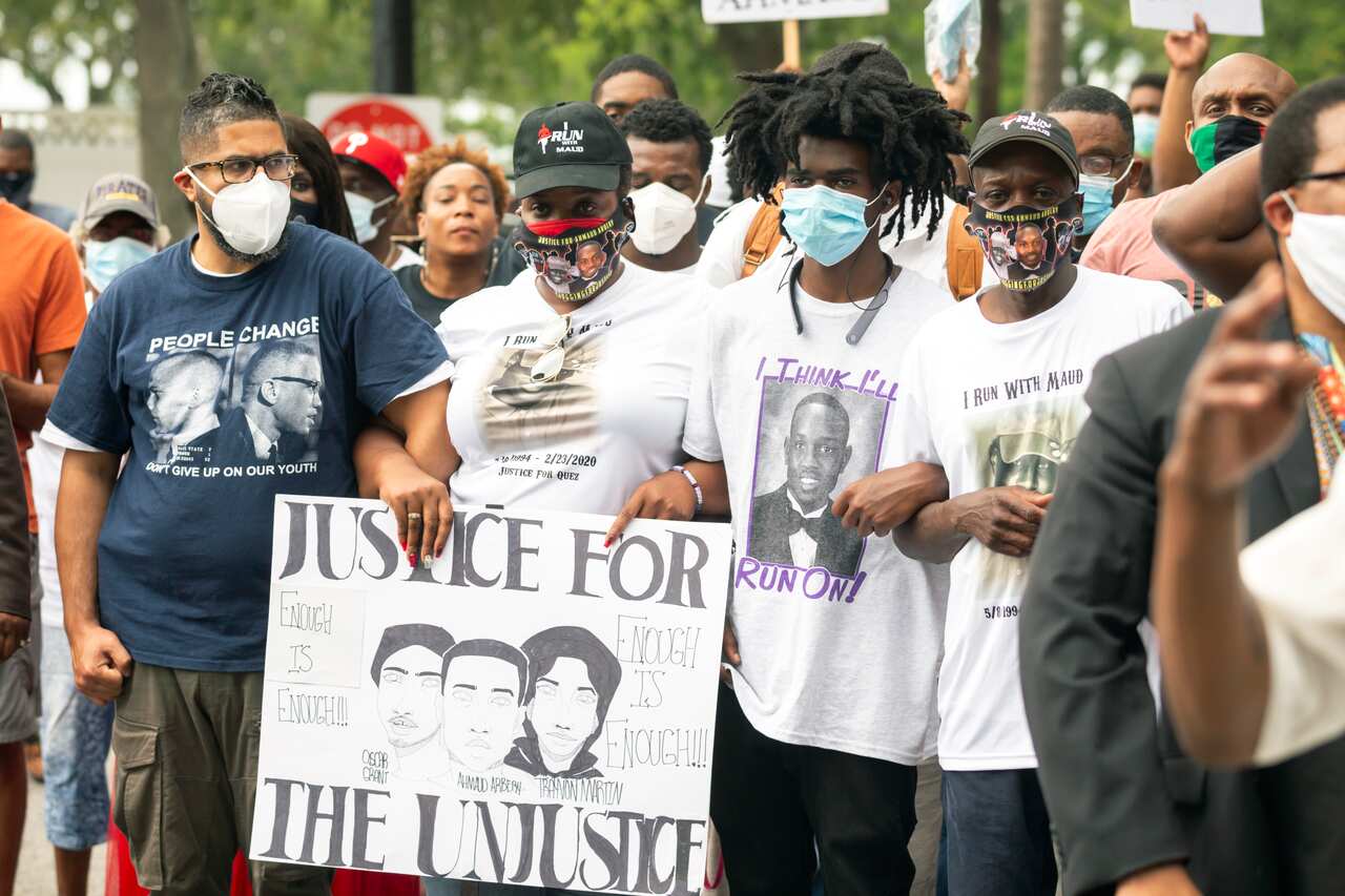 A group of protesters march from the Glynn County Courthouse to a police station after a rally to protest the shooting of Ahmaud Arbery, 