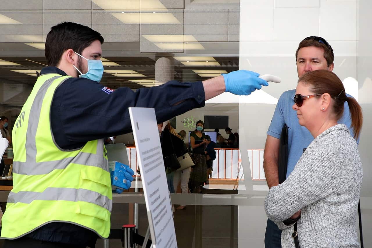 Customers have their temperatures taken before being allowed entry into a Perth store.