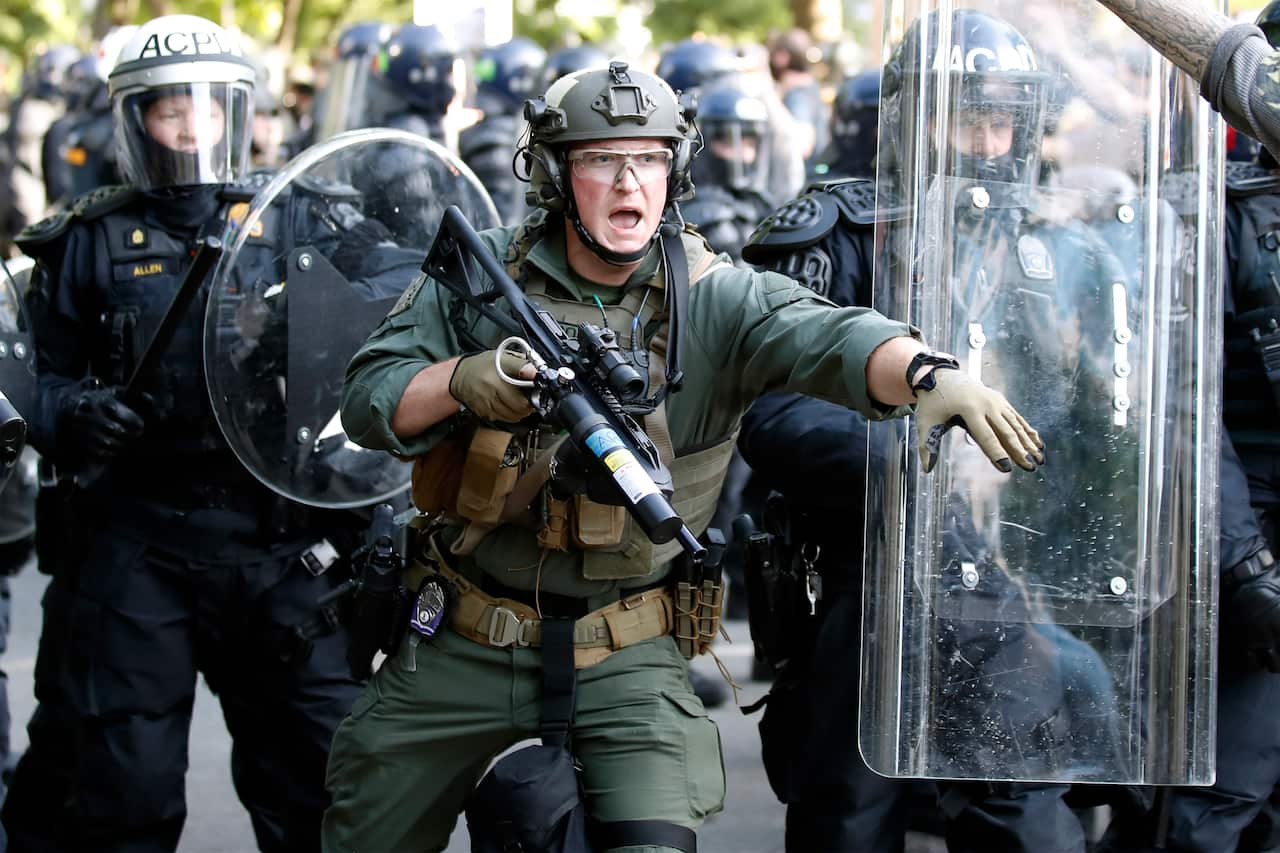 Police begin to clear demonstrators gather as they protest the death of George Floyd near the White House.