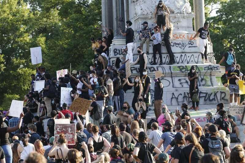 This Tuesday, June 2, 2020 file photo shows a large group of protesters gather around the statue of Confederate General Robert E. Lee