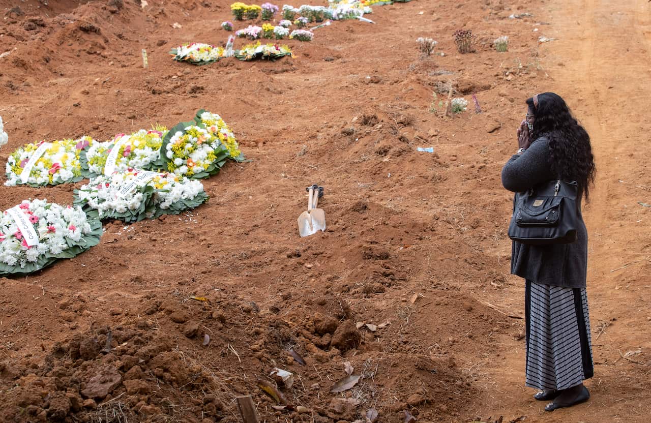 Vera Lucia Souza mourns her 47-year-old brother Paulo Roberto da Silva, who died of COVID-19, during his burial at the Sao Luiz cemetery in Sao Paulo, Brazil.