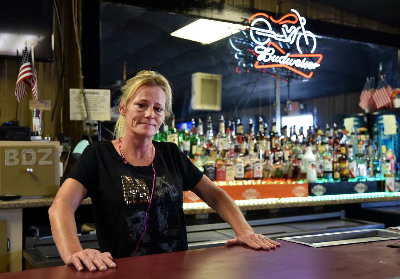 Owner of Big Daddy Zane's Gabrielle Ellison poses for a photo behind the bar top of her establishment in Odessa, Texas.