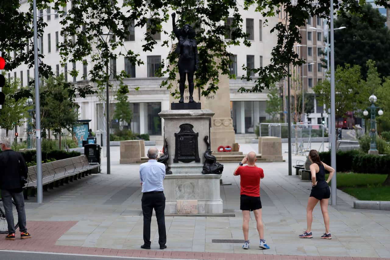 People look at the new statue entitled A Surge of Power.
