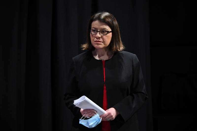 Health Minister Jenny Mikakos looks on as Premier Daniel Andrews addresses the media during a press conference on Thursday