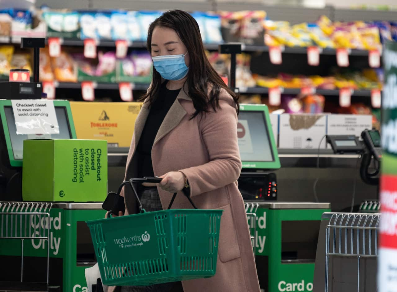 A shopper wearing a face mask inside a Woolworths shop.