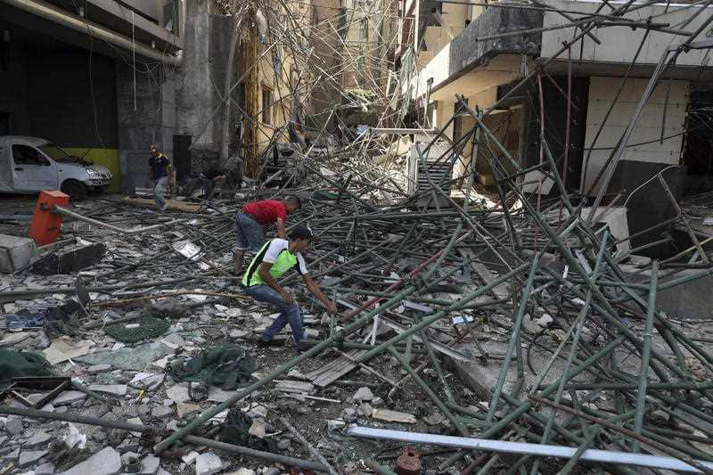 Workers remove rubble from damaged buildings near the site of an explosion on Tuesday that hit the seaport of Beirut, Lebanon, Thursday, Aug. 6, 2020