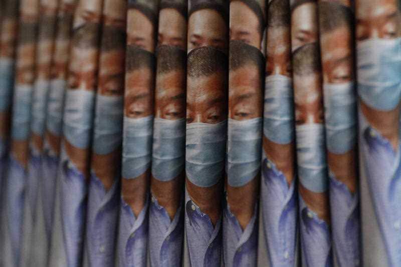 Copies of Apple Daily newspaper with front pages featuring Hong Kong media tycoon Jimmy Lai