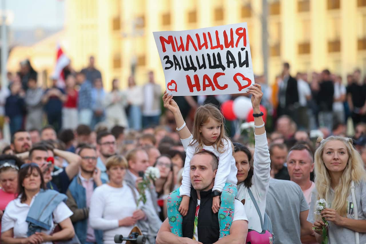 People protest in Independence Avenue near the Belarusian Government House and the offices of the Central Election Commission of Belarus on 14 August.