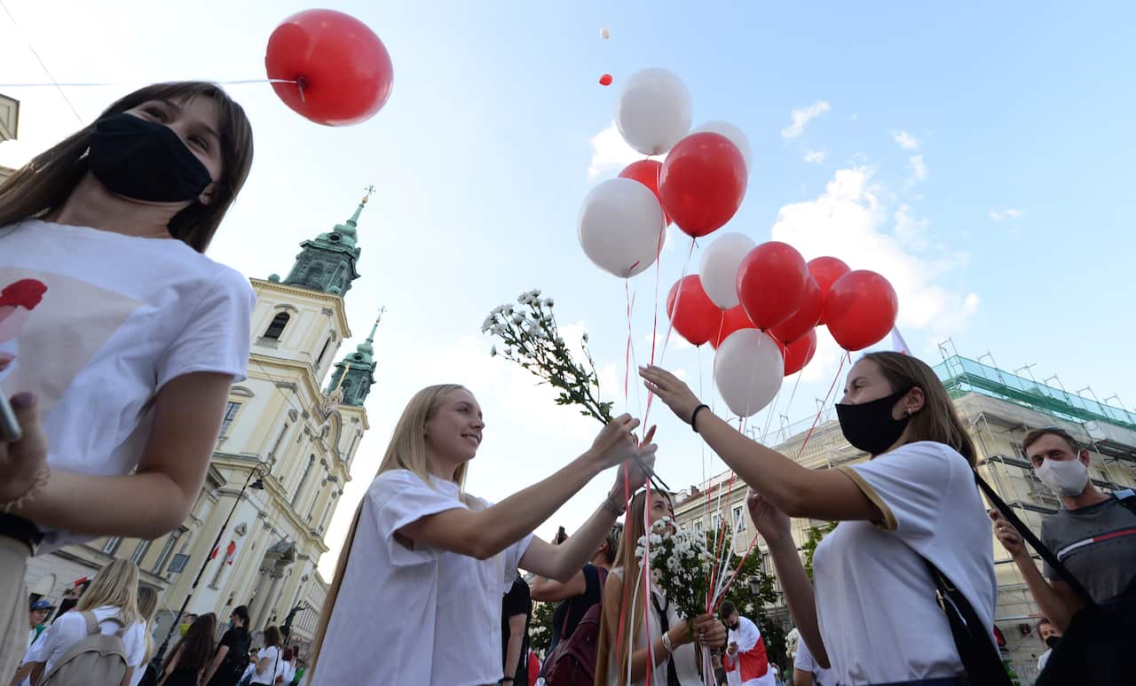 Hundreds of people march in Warsaw, Poland, in support of Belarusian demonstrators on 14 August.