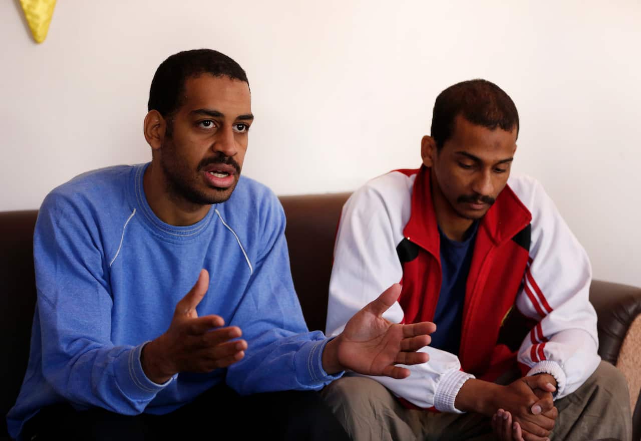 In this March 30, 2019, file photo, Alexanda Amon Kotey, left, and El Shafee Elsheikh speak during an interview at a security center in Kobani, Syria.