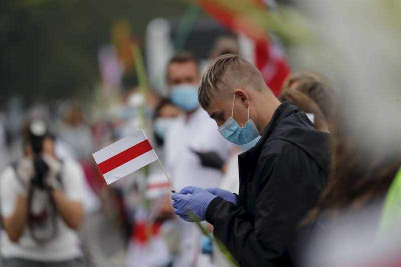 People in a human chain near Medininkai, Lithuanian-Belarusian border crossing east of Vilnius