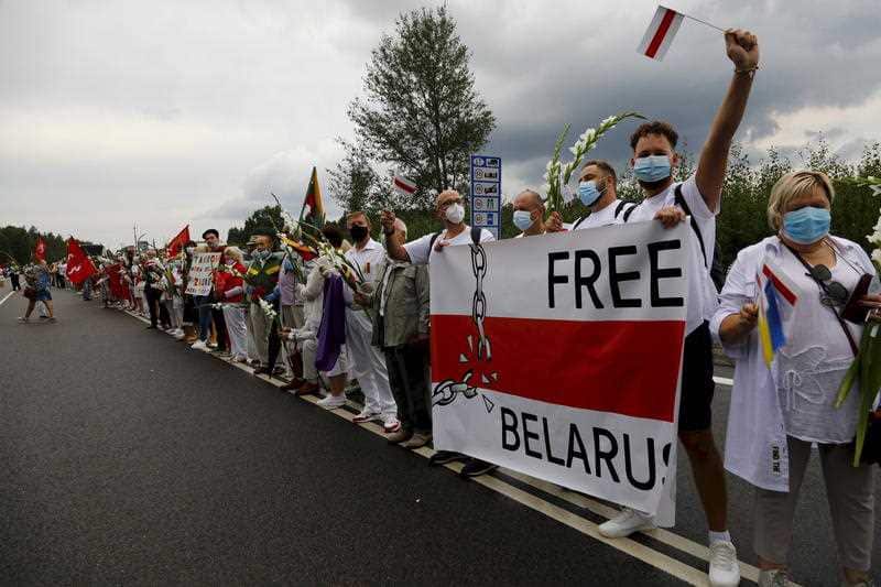 People participate in a human chain in Medininkai, Lithuania, 23 August 2020