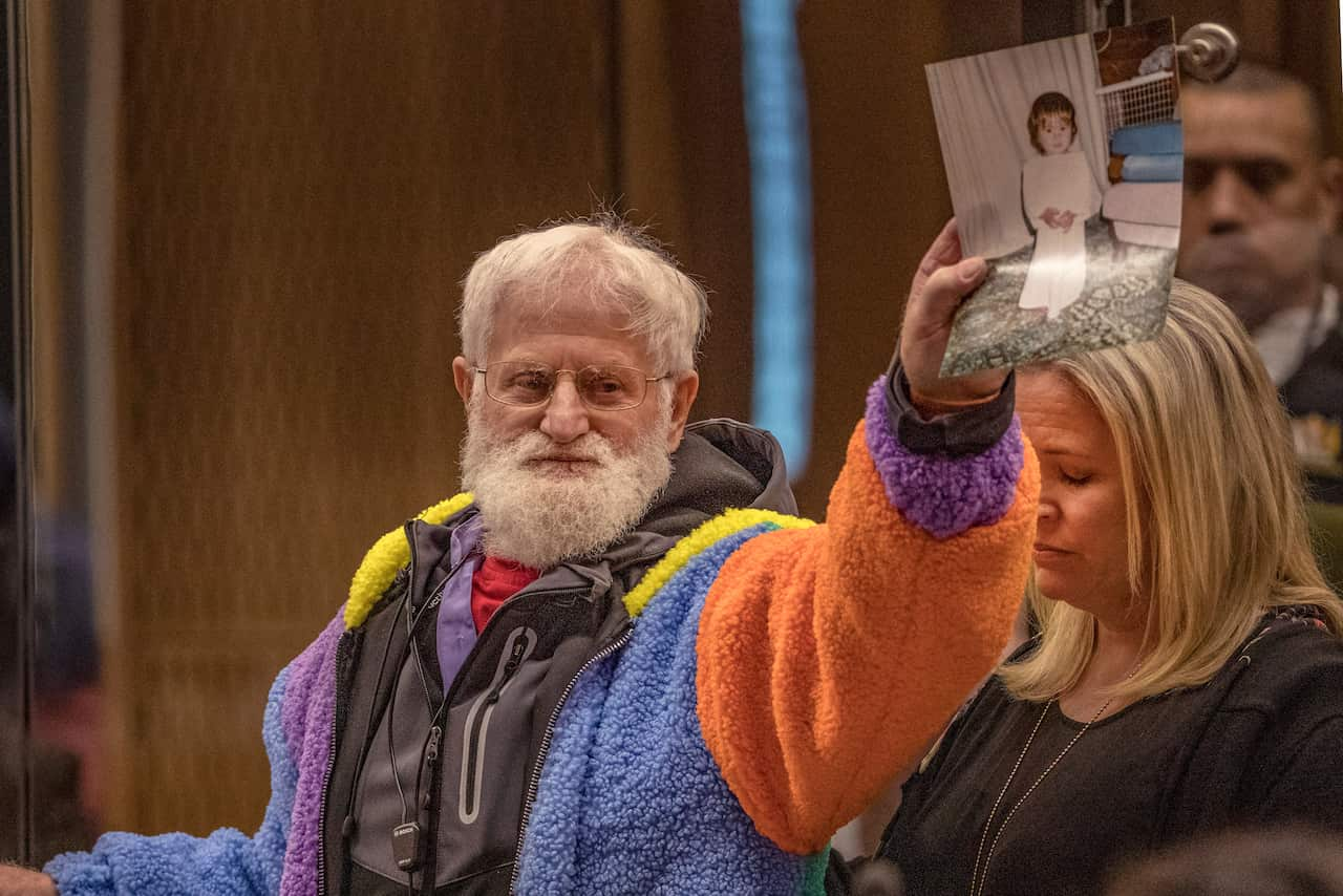 John Milne holds a photograph of his son, Sayyad Milne, who was killed in the Christchurch shooting.