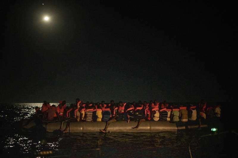 Men from different African nationalities wait to be assisted by crew members of the Louise Michel and Astral rescue vessels. 