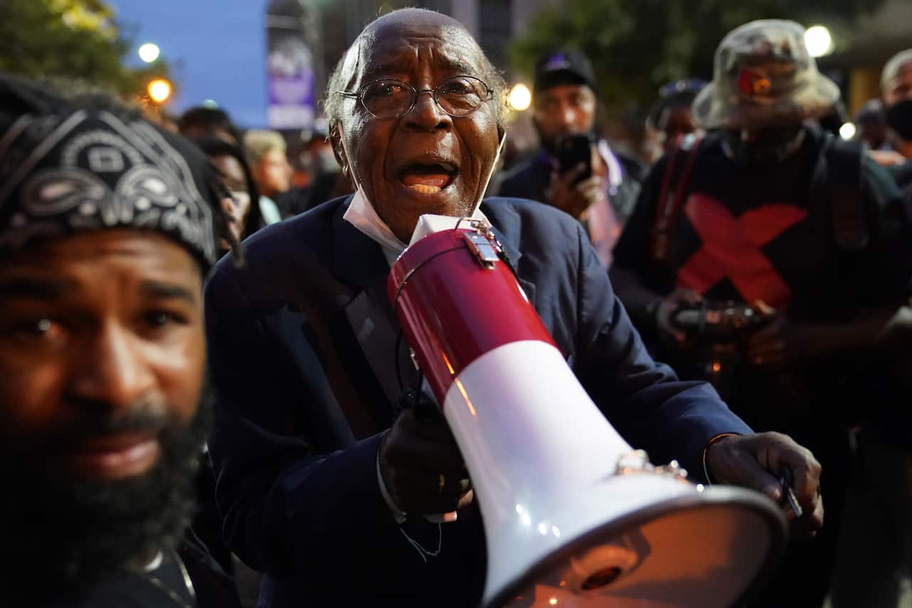 Reverend Dr. Charles Elliott Jr speaks with demonstrators in Louisville on 24 September.