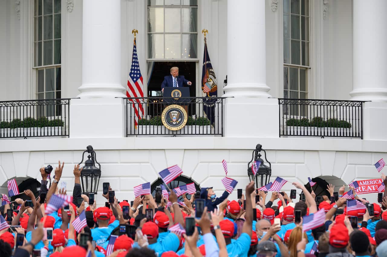 President Donald Trump speaks from the Truman Balcony of the White House in Washington on 10 October.