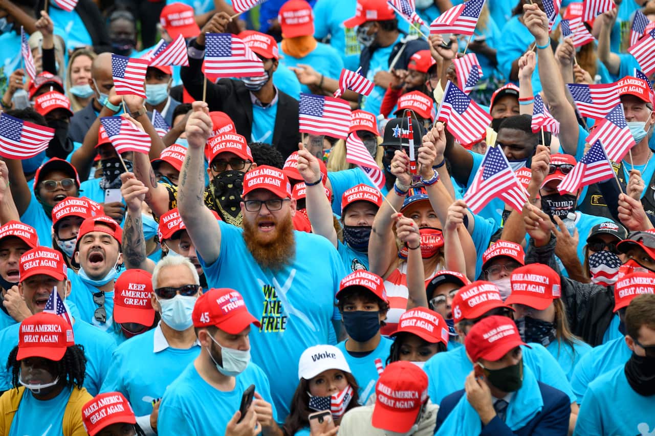 Supporters of President Donald Trump gather at the White House in Washington on Saturday, 10 October.