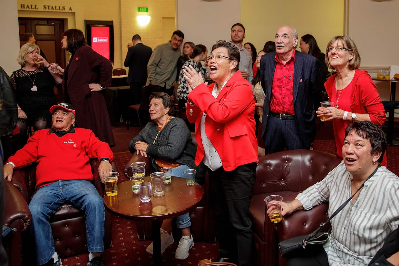 Labour supporters cheer as they watch the results come in during the New Zealand Labour party election night event in Auckland, Saturday, October 17, 2020. (AAP Image/David Rowland) NO ARCHIVING