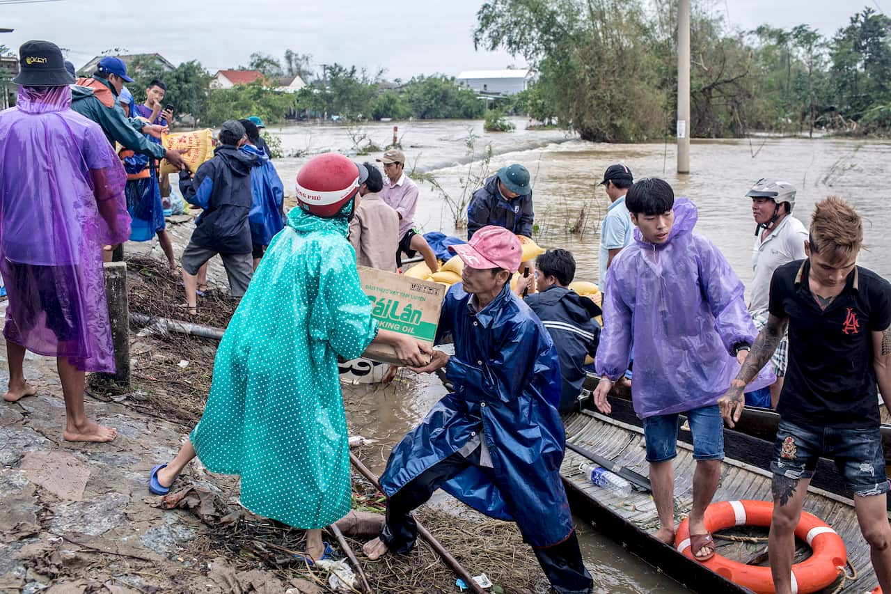 Local people and volunteers deliver aid in Quang An Commune, Thua Thien Hue, Vietnam, 20 October 2020 