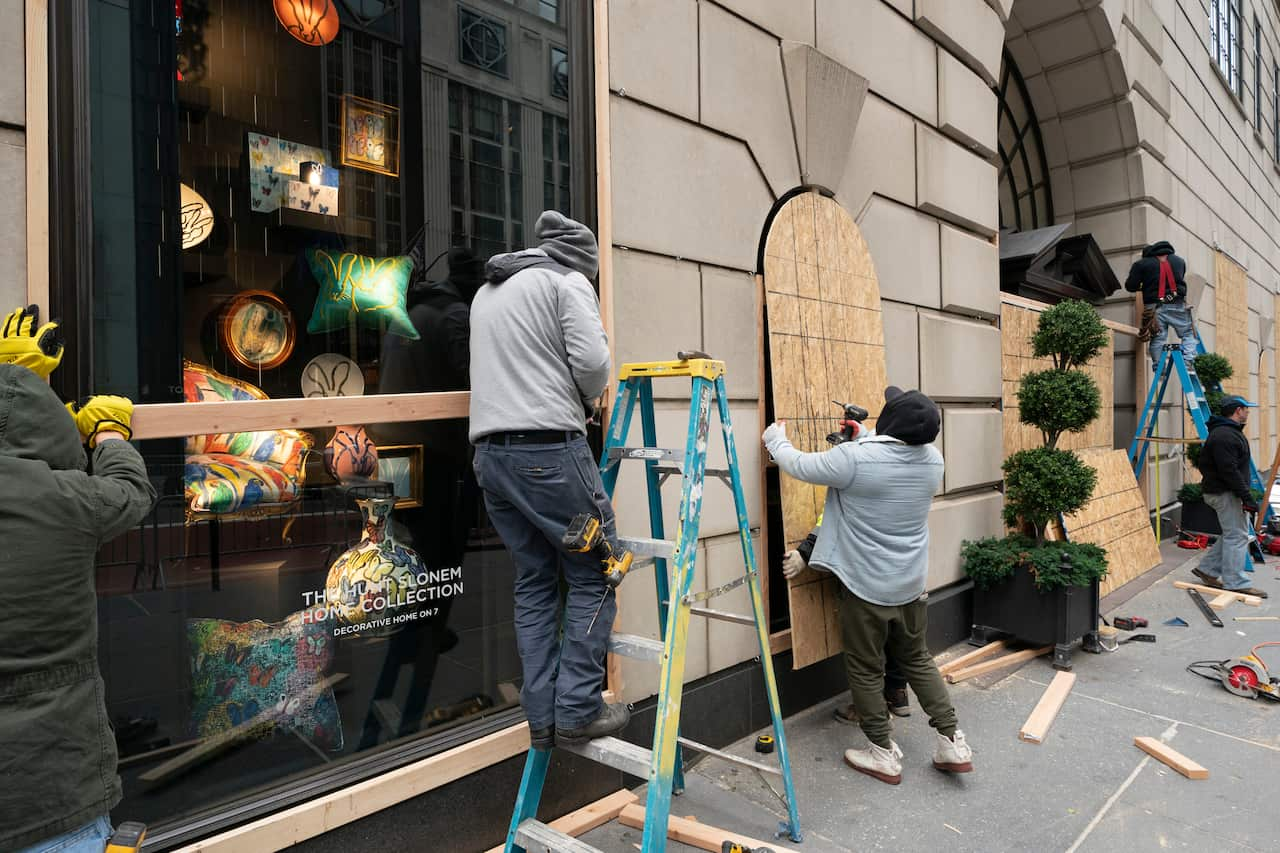 Workers board up Bergdorf Goodman department store, Monday, 2 November, 2020, in New York ahead of the presidential election.