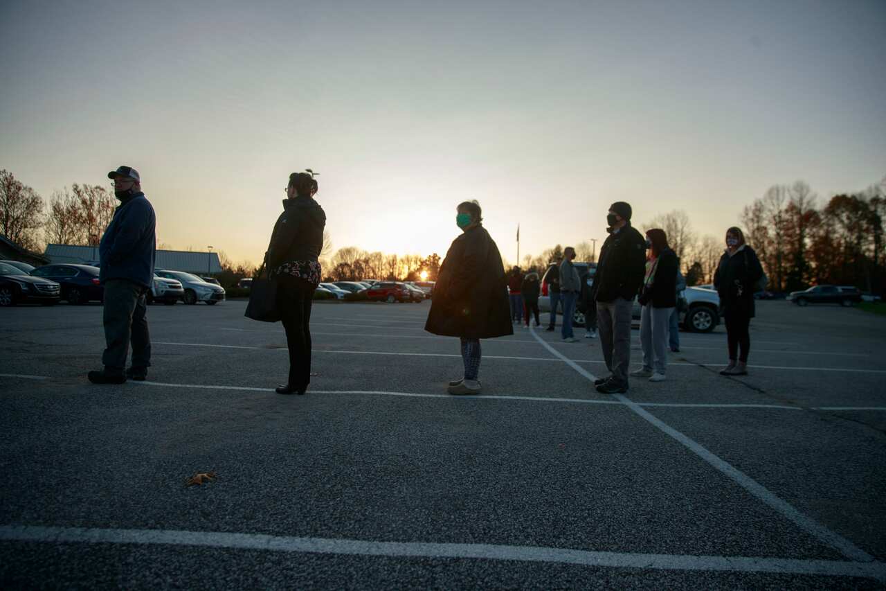 Voters line up to cast their ballots at St. John the Apostle Catholic Church.