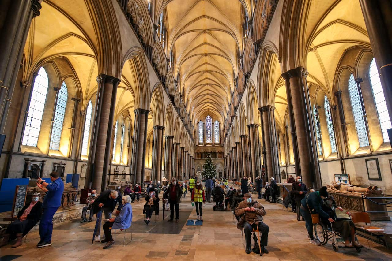 Members of the British public wait to receive the coronavirus vaccine at Salisbury Cathedral.