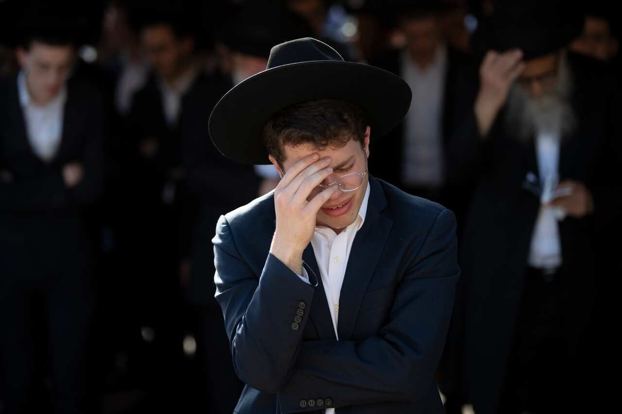 Ultra-Orthodox Jews in Petah Tikva mourn during the funeral of a victim of the stampede