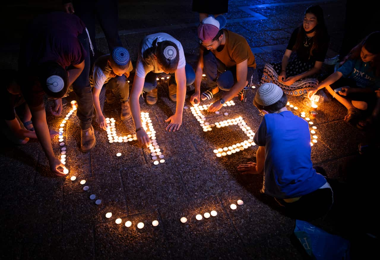 Israeli youths light candles in memory of the 45 ultra-Orthodox Jews killed in a stampede at a religious festival on Friday.
