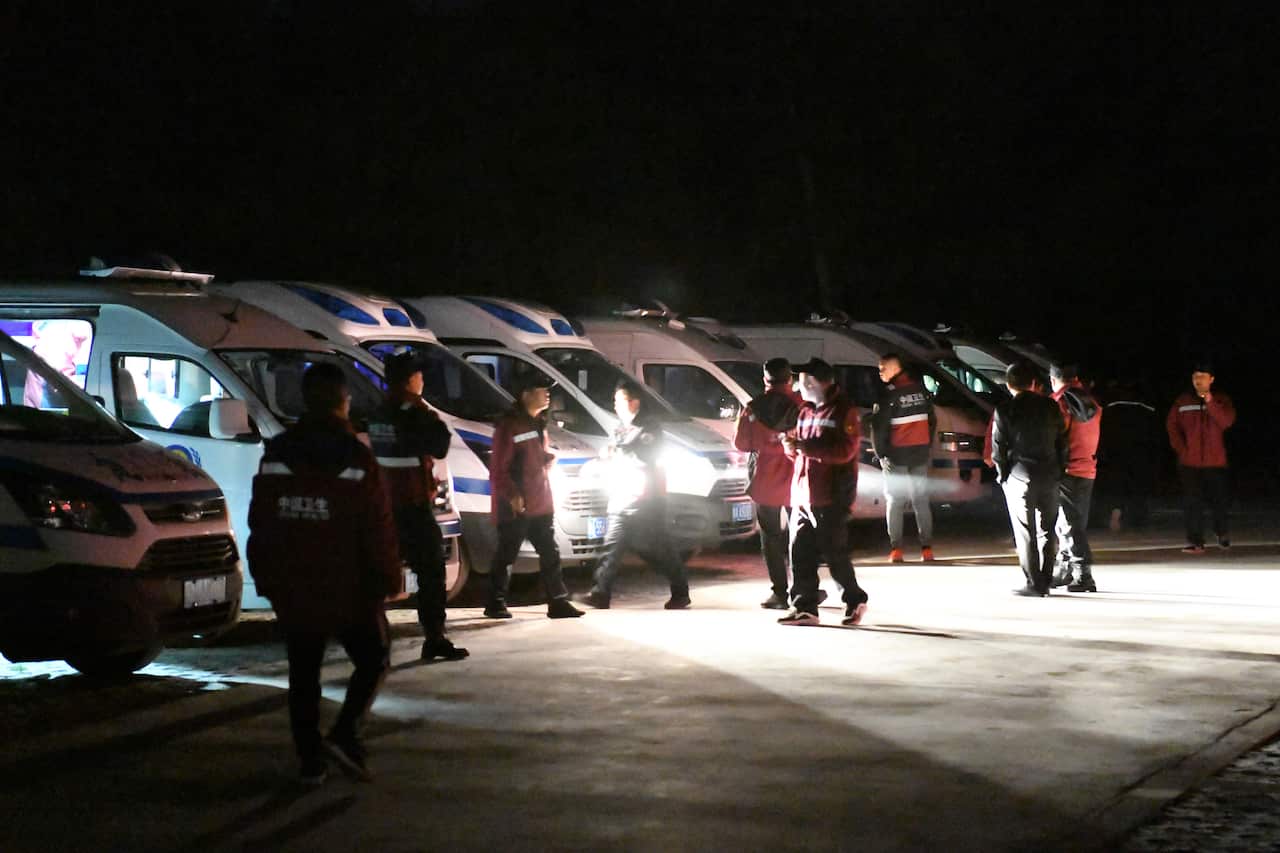 Emergency personnel and vehicles wait on standby at the Yellow River Stone Forest tourist site in Baiyin in northwestern China's Gansu Province.