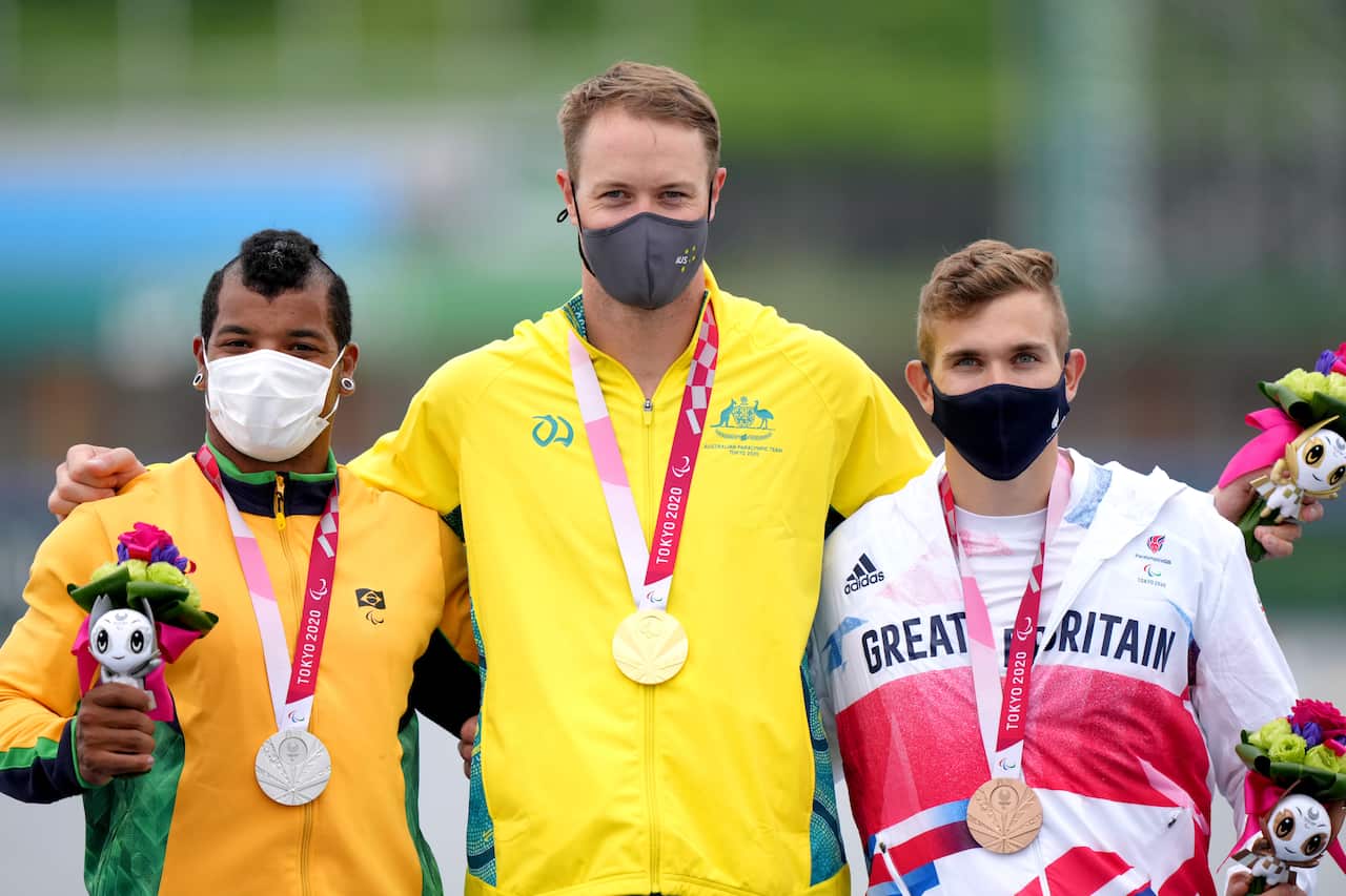 Australia's Curtis McGrath (centre) celebrates with his gold medal.