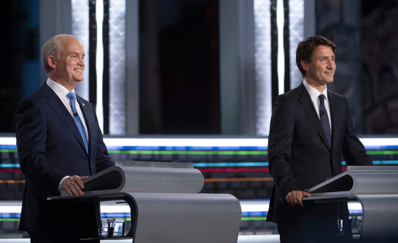 Conservative leader Erin O'Toole, left, and Liberal leader Justin Trudeau smile during the federal election French-language leaders debate, Wednesday, Sept. 8, 2021, in Gatineau, Quebec. (Justin Tang/The Canadian Press via AP)
